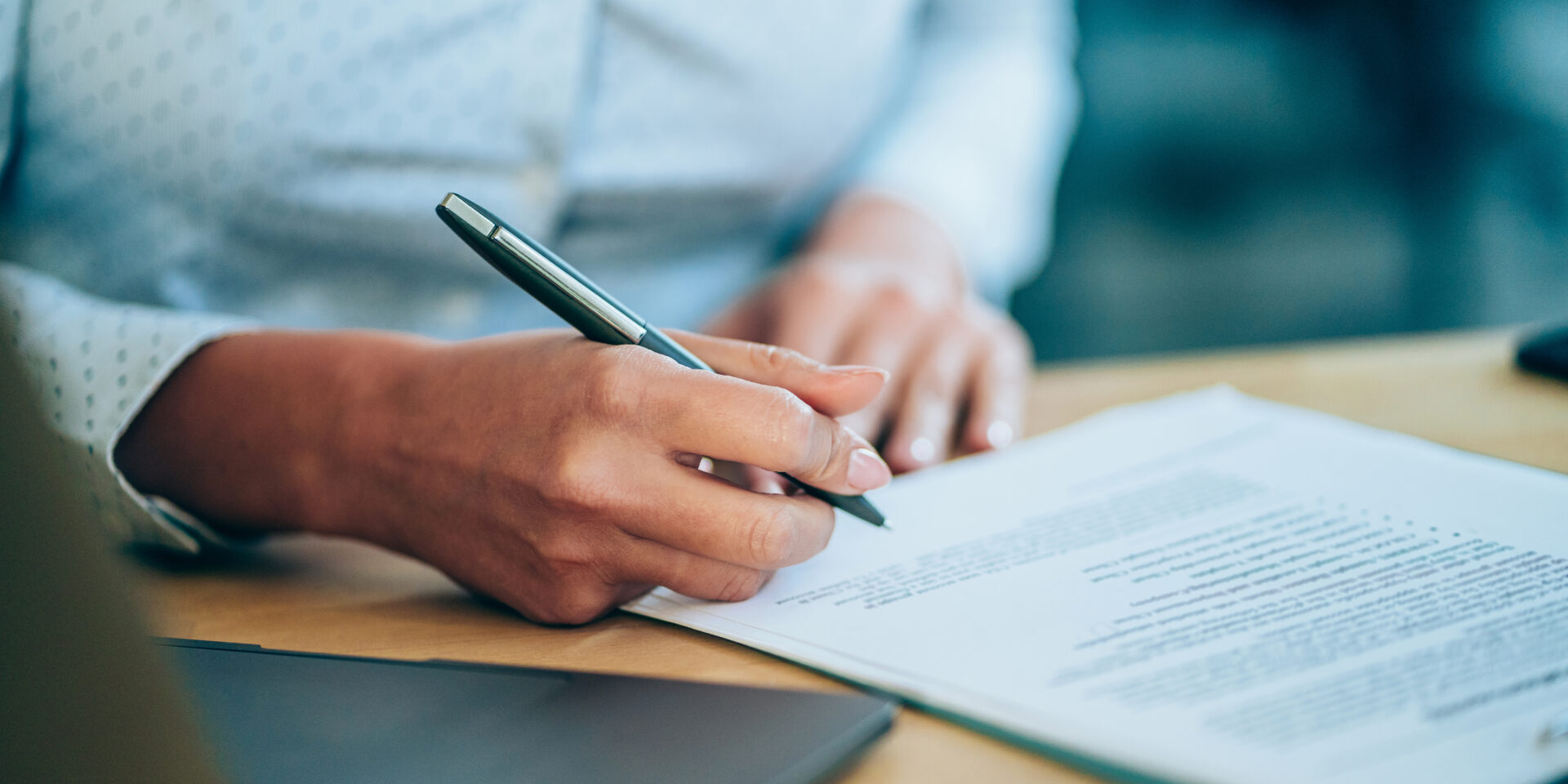 Businesswoman checking agreement before signing.