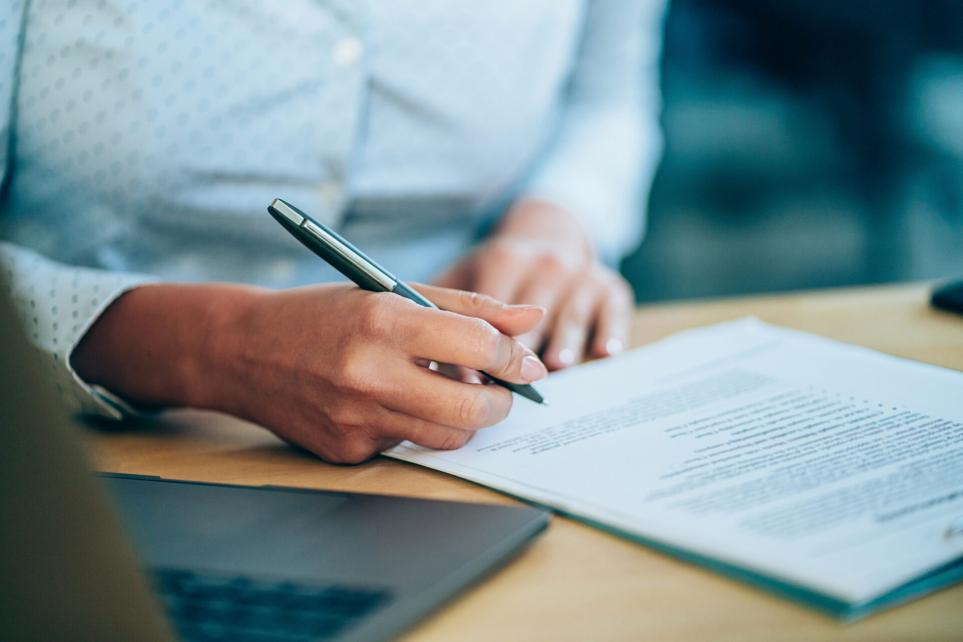 Businesswoman checking agreement before signing.