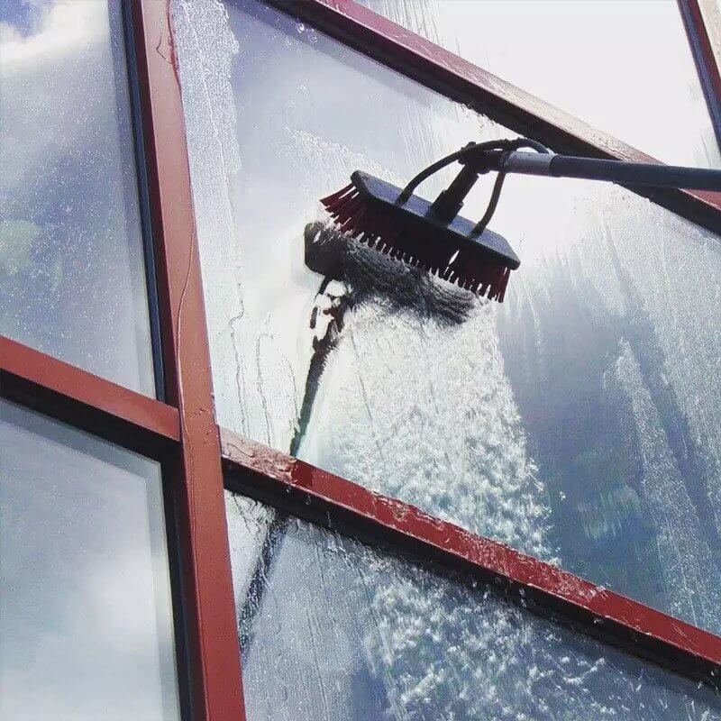 A water fed pole cleaning windows.